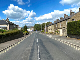 View down, Pendle Road, with houses, distant hills, and a cloudy sky in, Clitheroe, Lancashire, UK