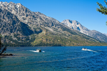 Fototapeta na wymiar Passing shuttle boats on Jenny Lake in Grand Teton National Park