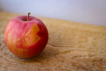 Red apple stand on a wooden surface