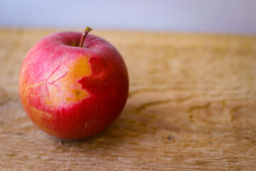 Red apple stand on a wooden surface