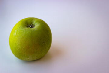 Green apple stand on a white surface