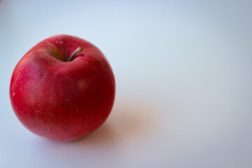 Red apple stand on a white surface