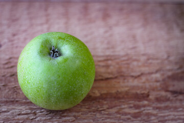 Green apple stand on a wooden surface