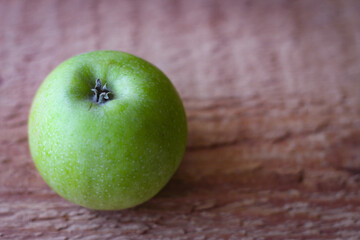 Green apple stand on a wooden surface