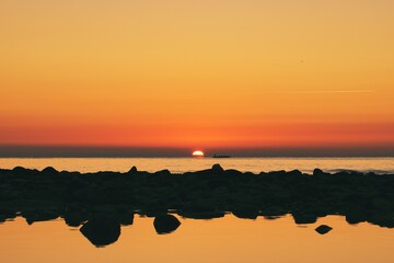 Sunrise at the beach and the rowers training in Spain © ruthlaguna