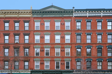 old fashioned apartment building facade with ornate roofline decorations