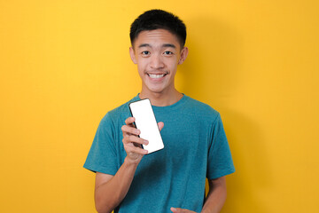 Happy Excited Young Asian man shock showing white phone screen at camera,