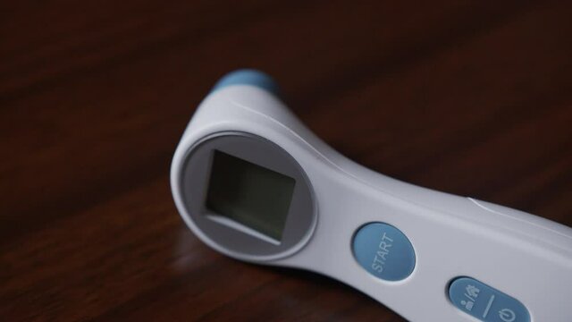 Close Up Tilt of a Non-Contact Digital Thermometer
