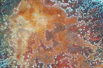 Red rust is caused by the condition that iron loses electrons when it reacts with water