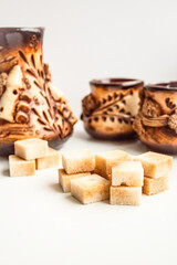 Cubes of brown cane sugar against the backdrop of a beautiful service