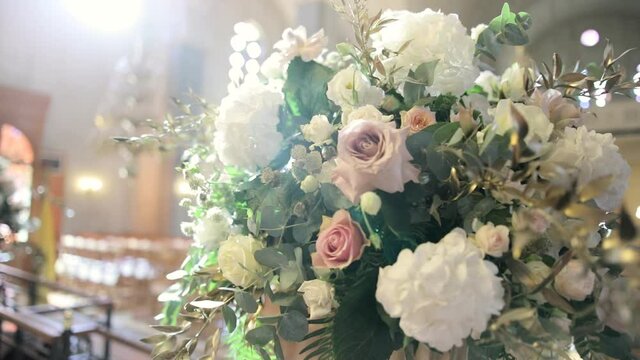beautiful flowers decoration on the stand in the church on wedding day