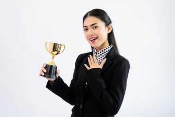 Successful young asian woman holding a trophy on white background