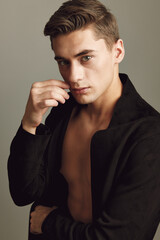 young man black shirt fashion hairstyle studio close-up