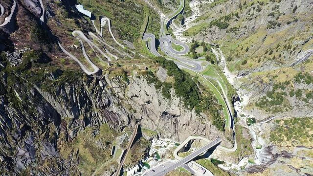 Aerial drone footage of the famous Gotthard pass mountain road and the devil's bridge near Andermatt in Canton Uri in Switzerland in the alps. Shot with a rotation motion.
