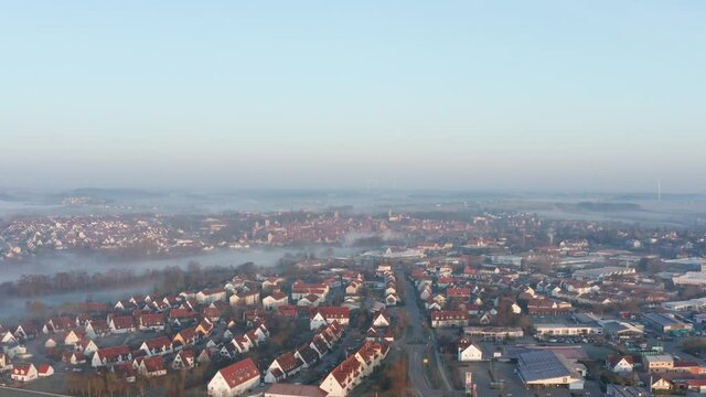 Drone flight over foggy city.