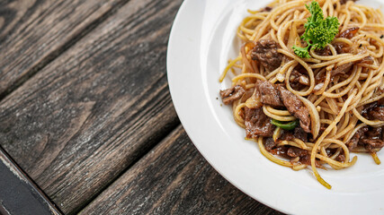 spaghetti with white plate on top table