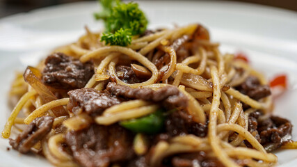 spaghetti with white plate on top table