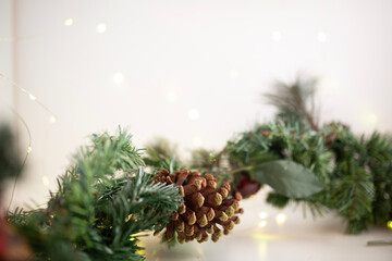 festive christmas wreath with gold bells lying on a white backdrop to form a frame christmas scene