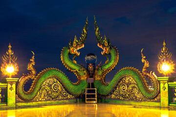 Background of Thailand's Chonburi religious attractions (Wat Khao Phra Khru viewpoint), with beautiful Buddha and Phaya Naga statues, tourists always come to make merit and take pictures at night.