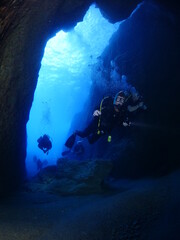 cave diving underwater scuba divers exploring caves and having fun ocean scenery sun beams and rays background