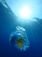 Fototapeta premium globe earth world in plastic bag underwater pollution ocean