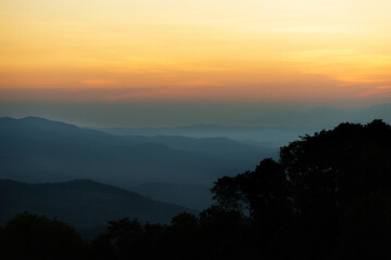 landscape in thailand sunrise on mountains peaceful with mist and sunlight at morning picturesque scenery outdoors travel.