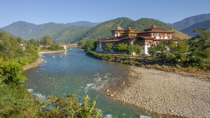 Magnificent panoramic view of Punakha dzong in Western Bhutan with Mo Chhu river and cantilever bridge
