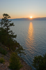 Fototapeta na wymiar The setting sun is reflected in the water of Lake Baikal.