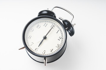 sets the alarm, women's hands set the time and set the alarm on black vintage alarm clocks , concept, selective focus, tinted image,