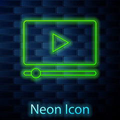 Glowing neon line Online play video icon isolated on brick wall background. Film strip with play sign. Vector.