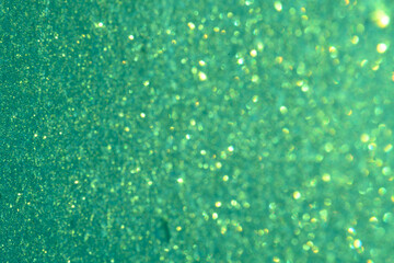 Shiny green background round sequins blurred Defocused
