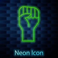 Glowing neon line Raised hand with clenched fist icon isolated on brick wall background. Protester raised fist at a political demonstration. Empowerment. Vector.