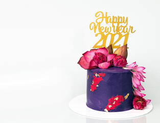 New Year Greeting Cake in Blue purple red and gold colours with Fresh Blue water Lilies