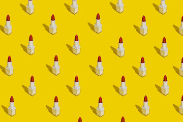 Make up pattern made with red lipstick on yellow background. Minimal beauty salon concept with trendy summer shadows. Flat lay, top view.