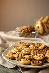 On wooden table on plate pile of cookies close-up.