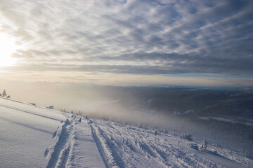 Beautiful windy clouds, beautiful view from the mountains in winter at sunset