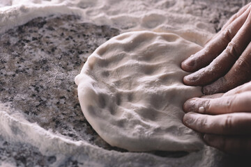 hand -rolled dough for pizza close up