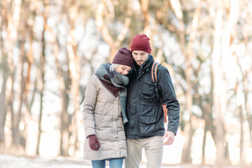 Fototapeta na wymiar loving couple walking in snowy winter, Vacation together. Young hipster couple. Winter love story, a beautiful stylish young couple.