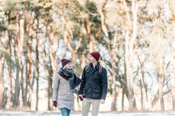 Fototapeta na wymiar loving couple walking in snowy winter, Vacation together. Young hipster couple. Winter love story, a beautiful stylish young couple.