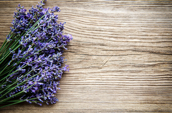 Fresh flowers of lavender bouquet, top view on old wooden background