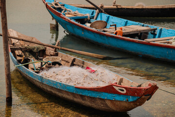 Fototapeta na wymiar Traditional Vietnamese fishing boats carrying nets and moored at Duy Vinh Fishing Village in Vietnam