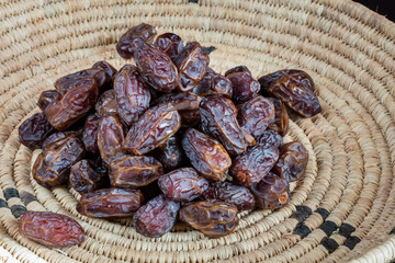 Dried dates with tea in a basket 