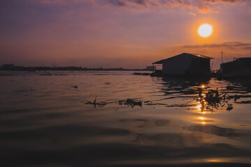 Fototapeta na wymiar Cinematic scenery of the sunset over the Mekong Delta in Vietnam, showing the daily life and culture