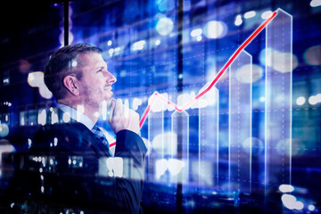 Fototapeta premium Businessman look at growth graph with night city