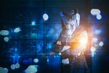 Confident male manager with head of rhino © Creativa Images
