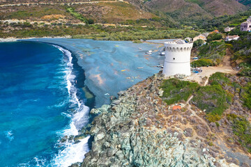 Drone aerial view of Plage de Nonza with the Genoese tower, the long black beach at the foot of the...