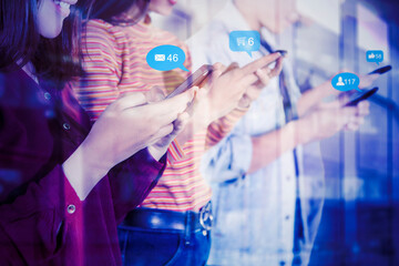 Four people using cellphone with social media icons