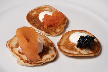 Blinis with Salmon, Red and Black Caviar with Sour Cream