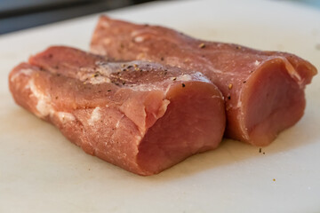 Cooking fresh meat in a dark kitchen 