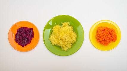 A set of ingredients for making salads. Mashed boiled potatoes, carrots, beets on a plate isolated on a white background. Flat lay